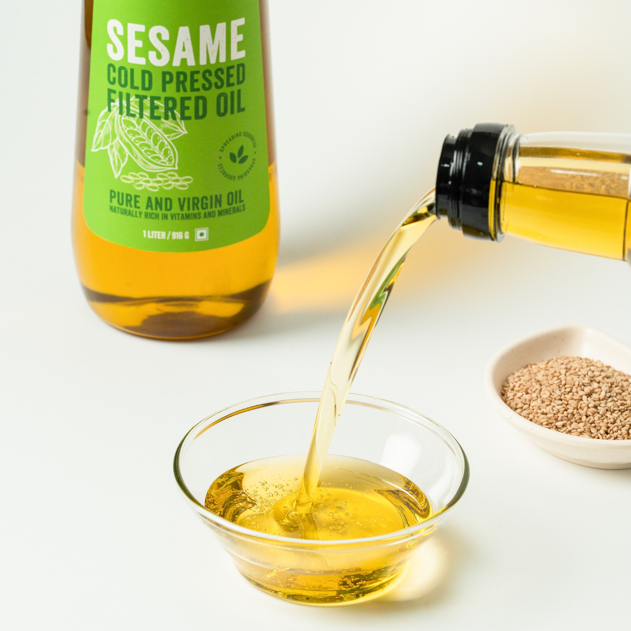 COLD PRESSED FILTERED SESAME OIL 1 L with sesame seeds in the background creating S