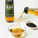 Amrutva Cold Pressed Black Sesame Seed Oil 500 ml pouring in a bowl