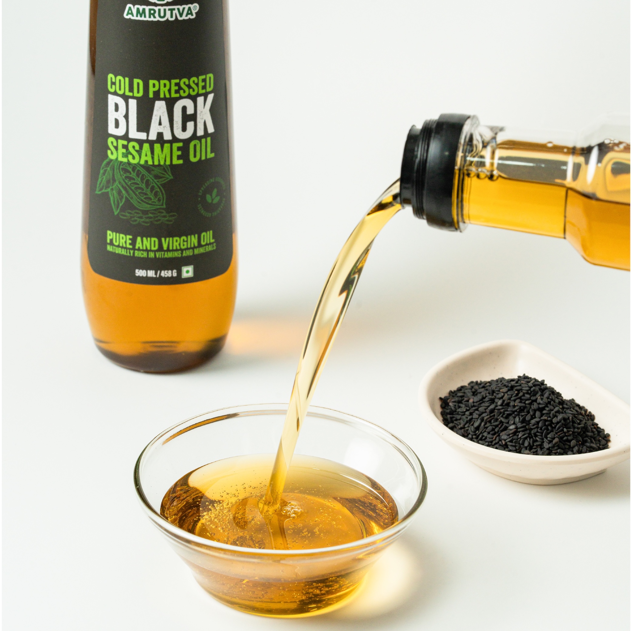 Amrutva Cold Pressed Black Sesame Seed Oil 500 ml pouring in a bowl