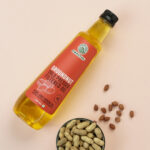 Amrutva Cold Pressed Groundnut Oil made with premium Indian peanuts using traditional wooden kolhus/chekku. This groundnut oil is natural; pure; and perfect for cooking with peanuts shown